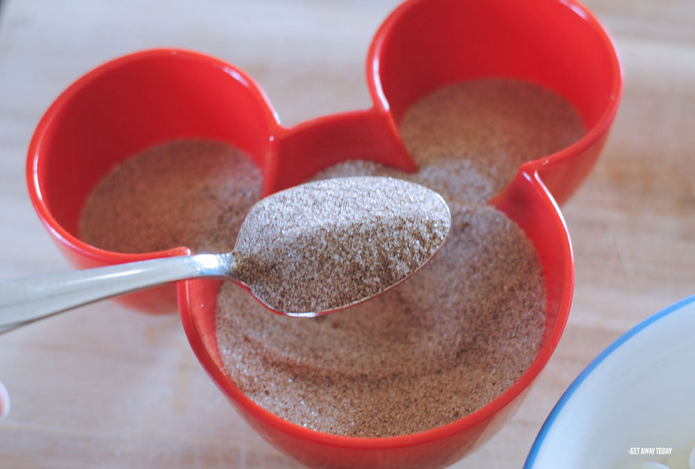 spoonful of cinnamon and sugar in red Micky Mouse bowl