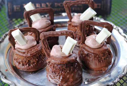Harry Potter Cauldron Cakes on display with white chocolate dipping sticks.