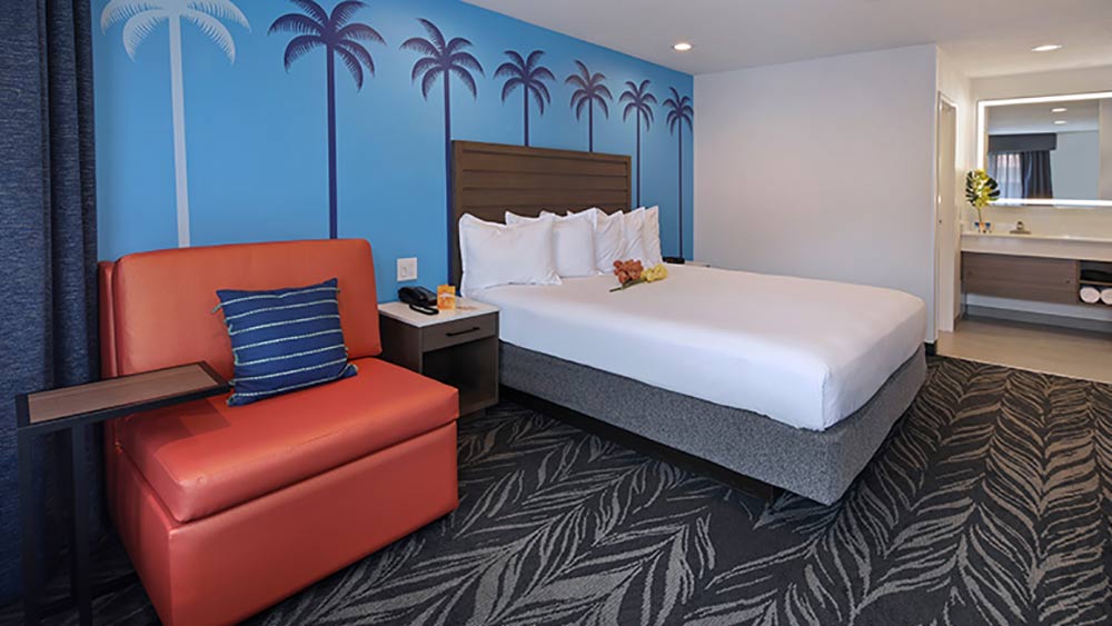 Best Disneyland Hotel for Large Families Tropicana Inn and Suites Room with Palm trees painted on wall