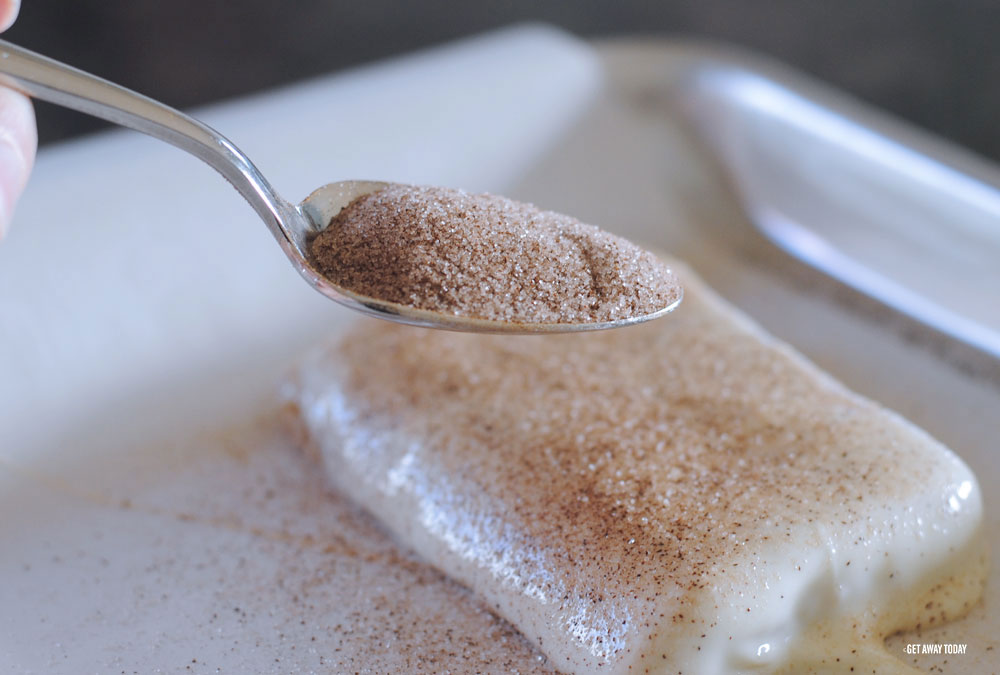 sprinkling spoonfuls of cinnamon and sugar on toffee