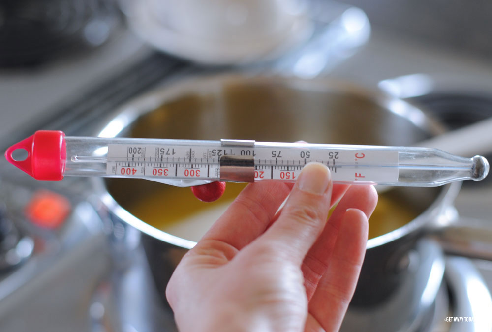 holding a food thermometer