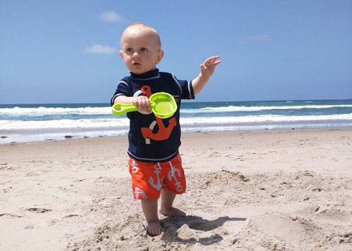 A baby on the sand at one of the beaches near Disneyland