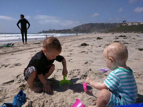 Boys playing in the sand at Laguna Beach, one of the beaches near Disneyland