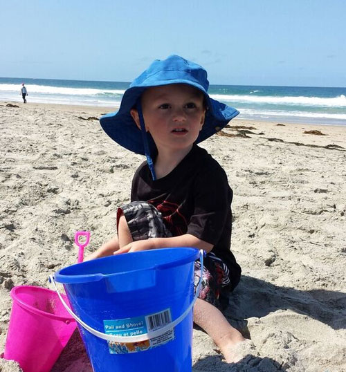 Boy playing in sand at one of the beaches near Disneyland