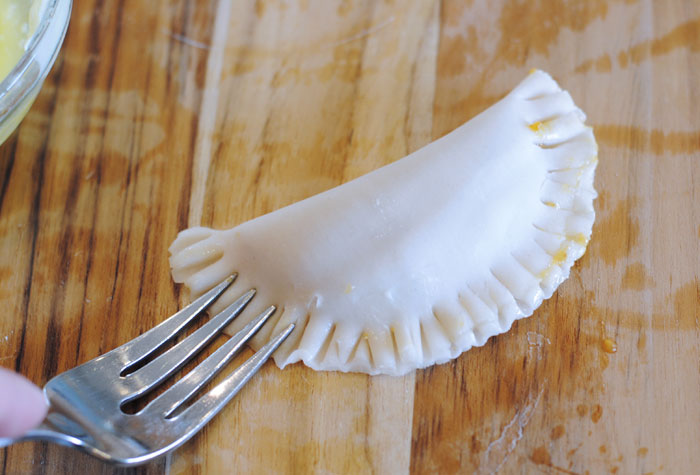 Harry Potter pumpkin pasties recipe pressing edges with a fork.